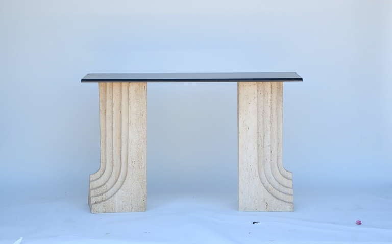 Pair of sculptural 70's Italian travertine and granite consoles by Carlo Scarpa. The granit tops can be replaced with a larger size cut of stone, depending on the project.

Travertine legs measures:
29.5