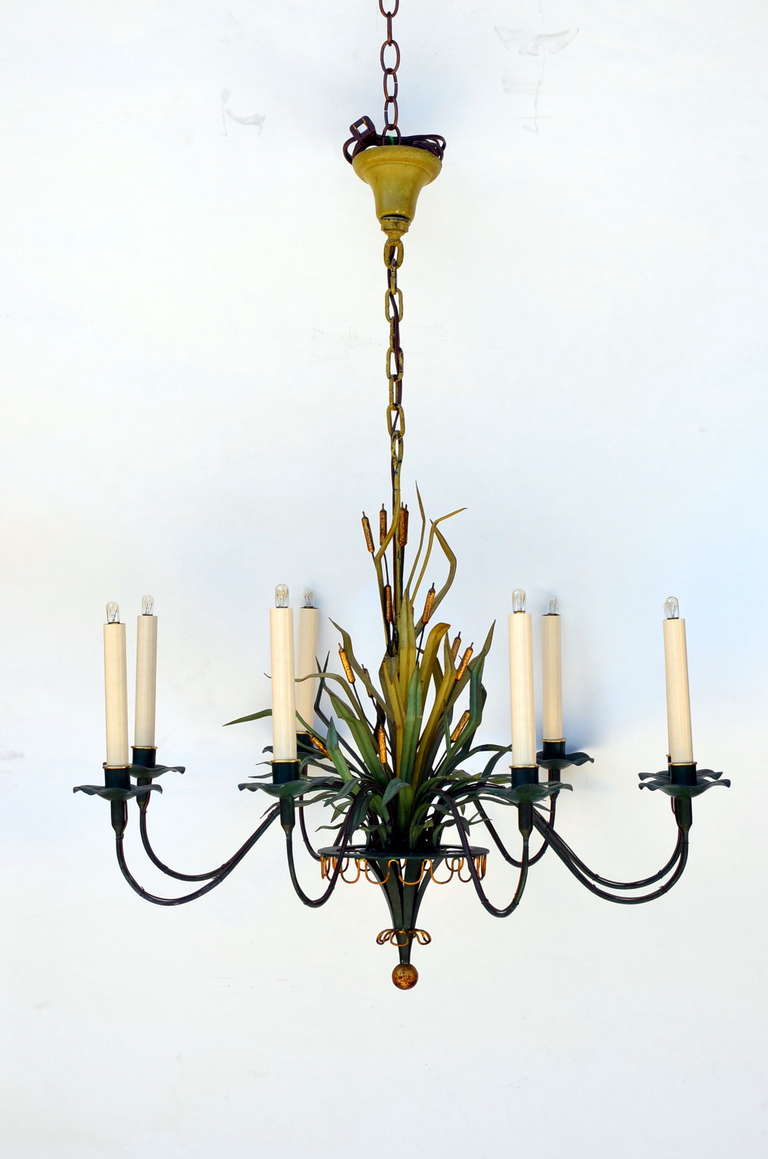 8 lights surround a bundle of cattails on this unique painted and gilt tole chandelier.