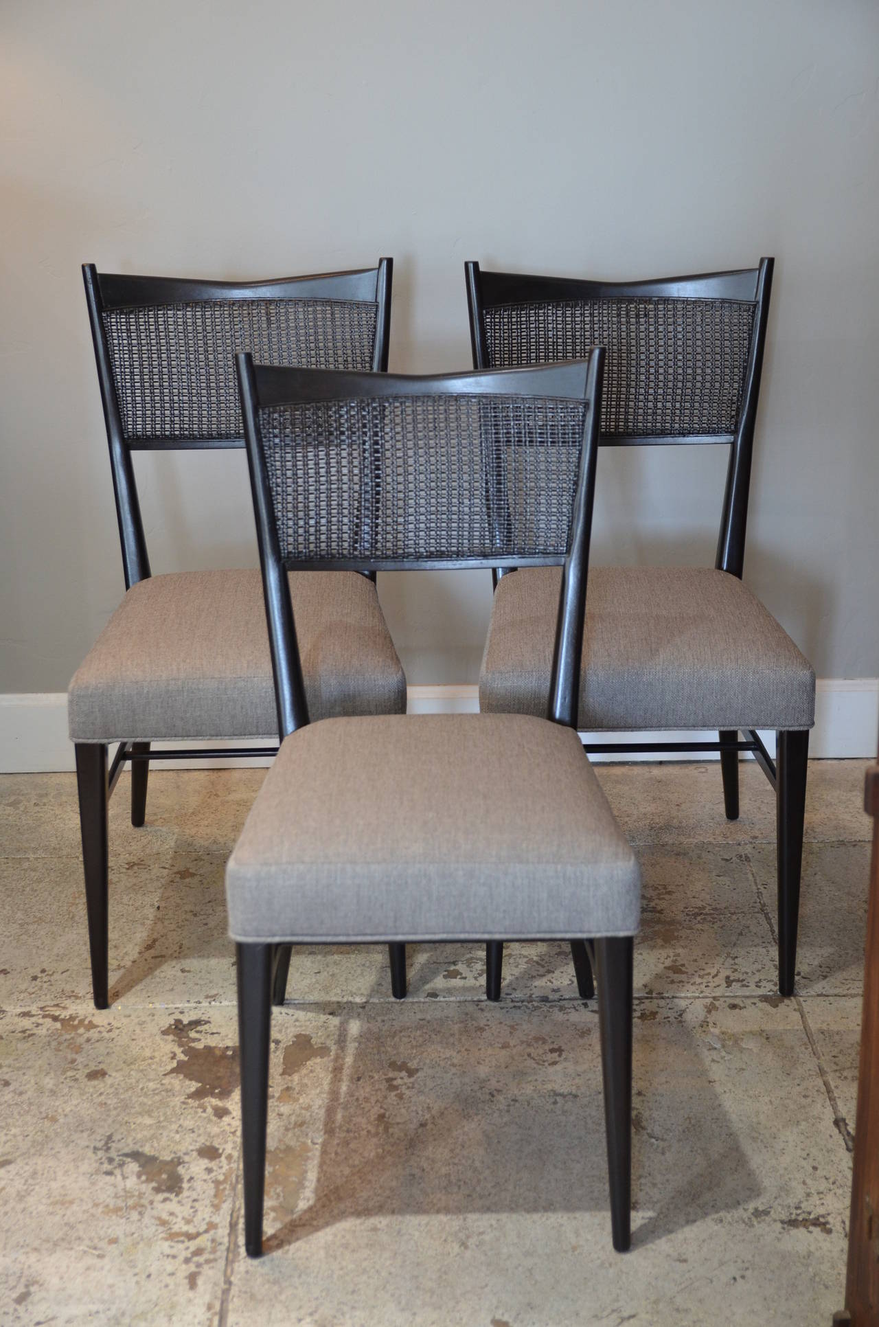 Set of three chic ebonized caned chairs by Paul McCobb. From the Connoisseur Collection. Restored and reupholstered.