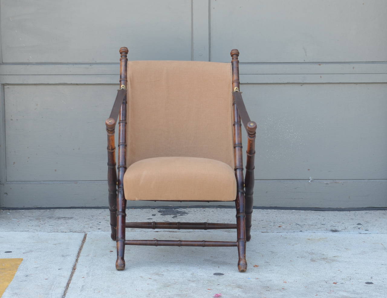 Pair of turned wood, linen and leather Campaign chairs by Maison Jansen.

Measures: Arm height 23