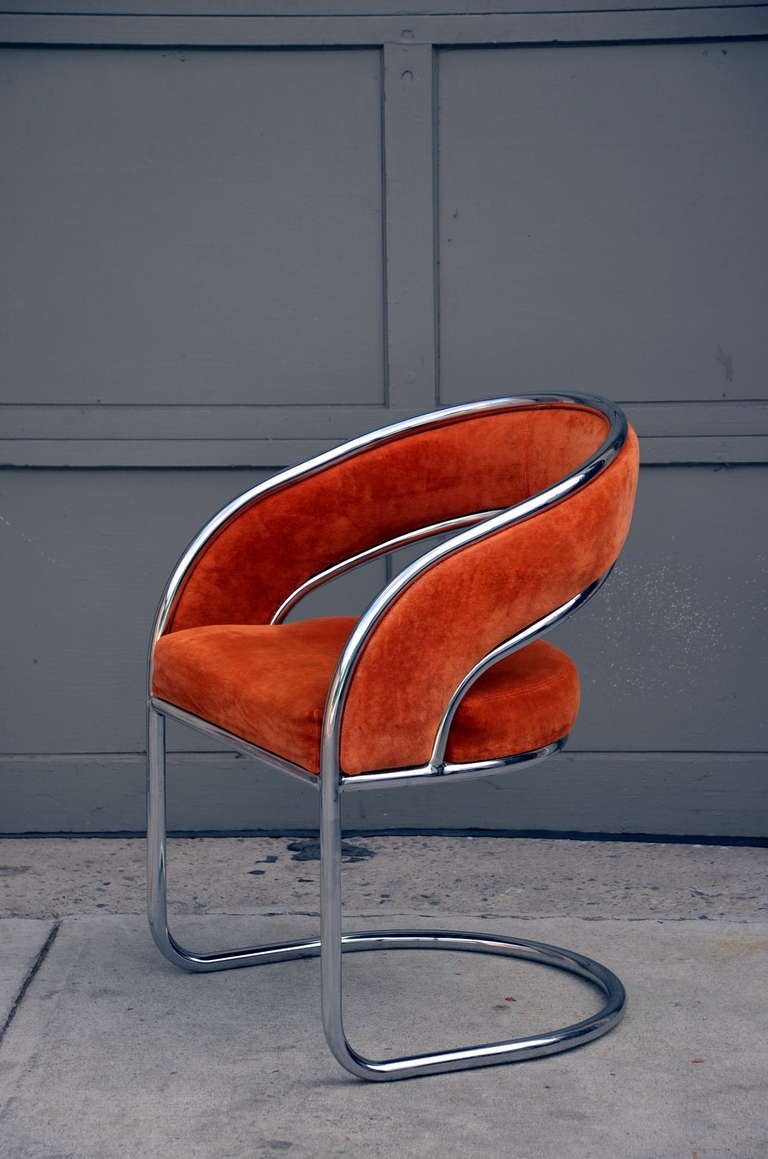 Unique 70's orange velvet and chrome armchair. Unusual banded back design.