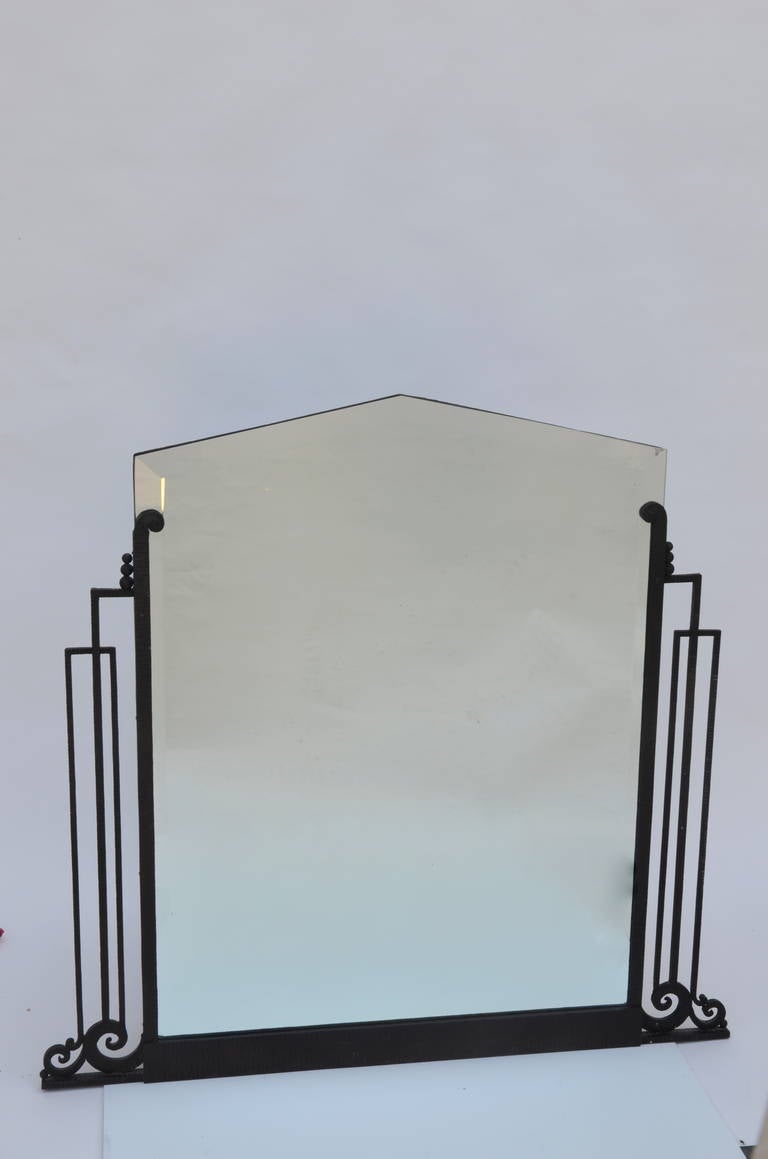 Elegant French Art Deco wrought iron and beveled mirror.
