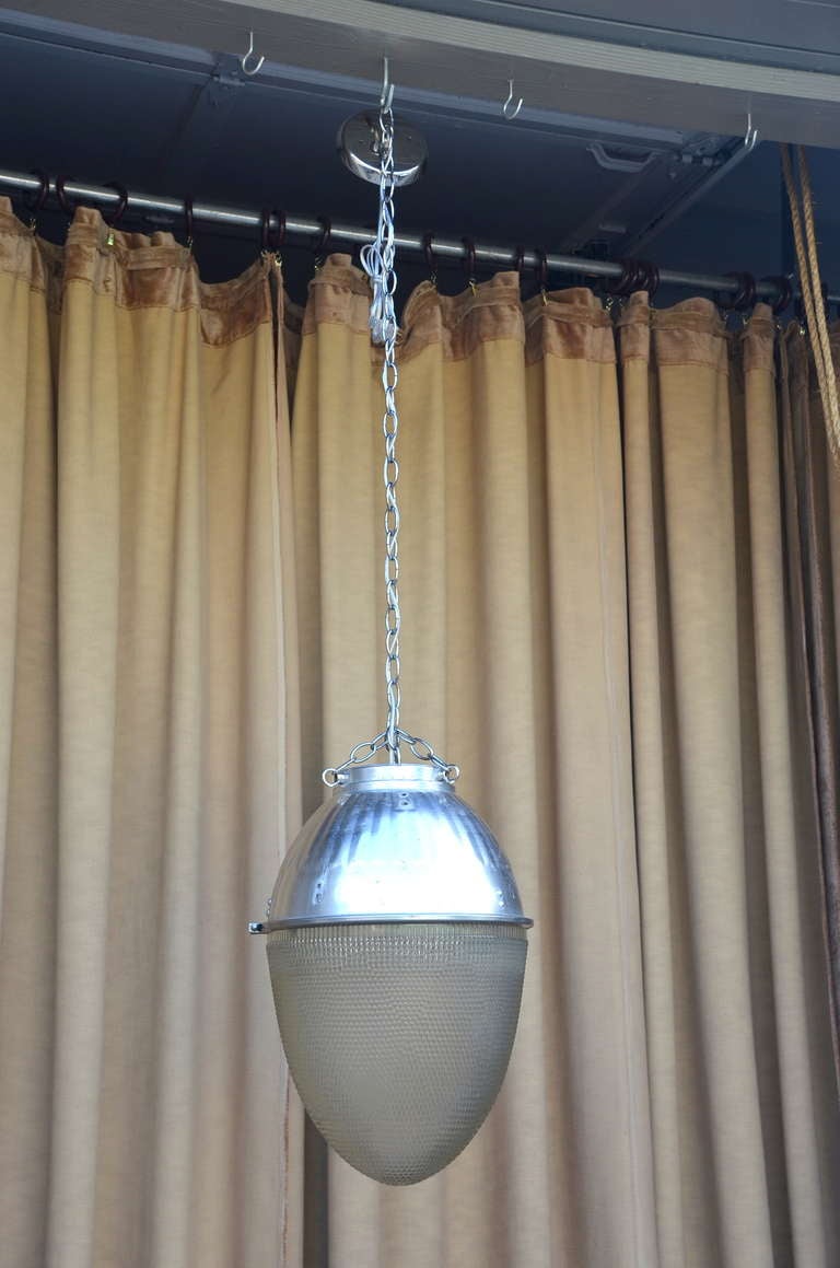 Beautiful 1930’s - 1950's hanging Pendant street light. Restored for interior use this unit would have adorned an exclusive residential neighborhood or hung impressively over an up scaled main boulevard. The glass globe gives a beautiful sparkle