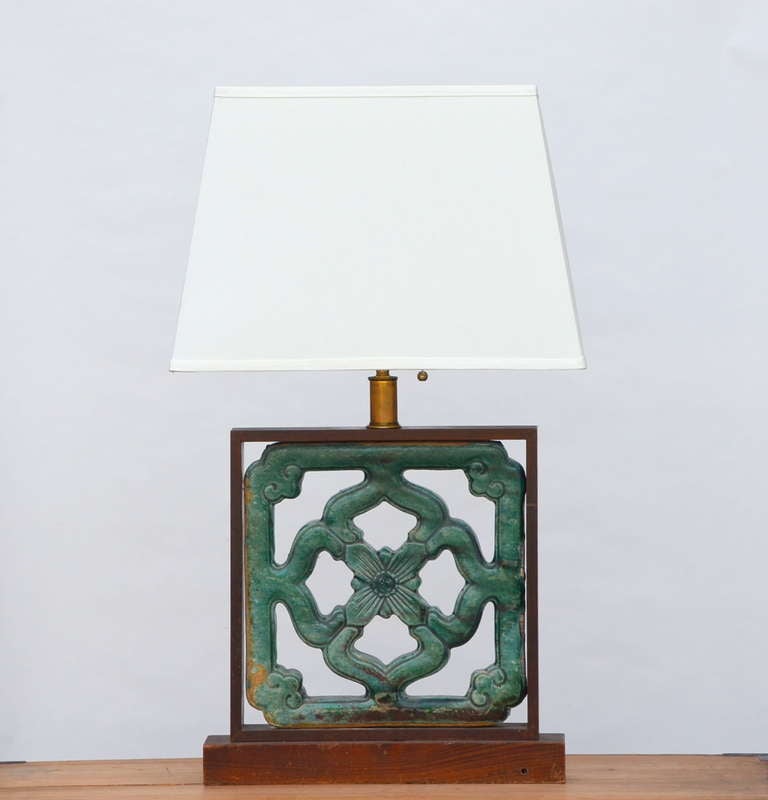 Rare late Ming dynasty glazed terracotta building ornament mounted as a Lamp.

A few of these terracotta vents were used by Greene & Greene for the construction of the Gamble House in Pasadena. Custom linen shade. Rewired.

Shade