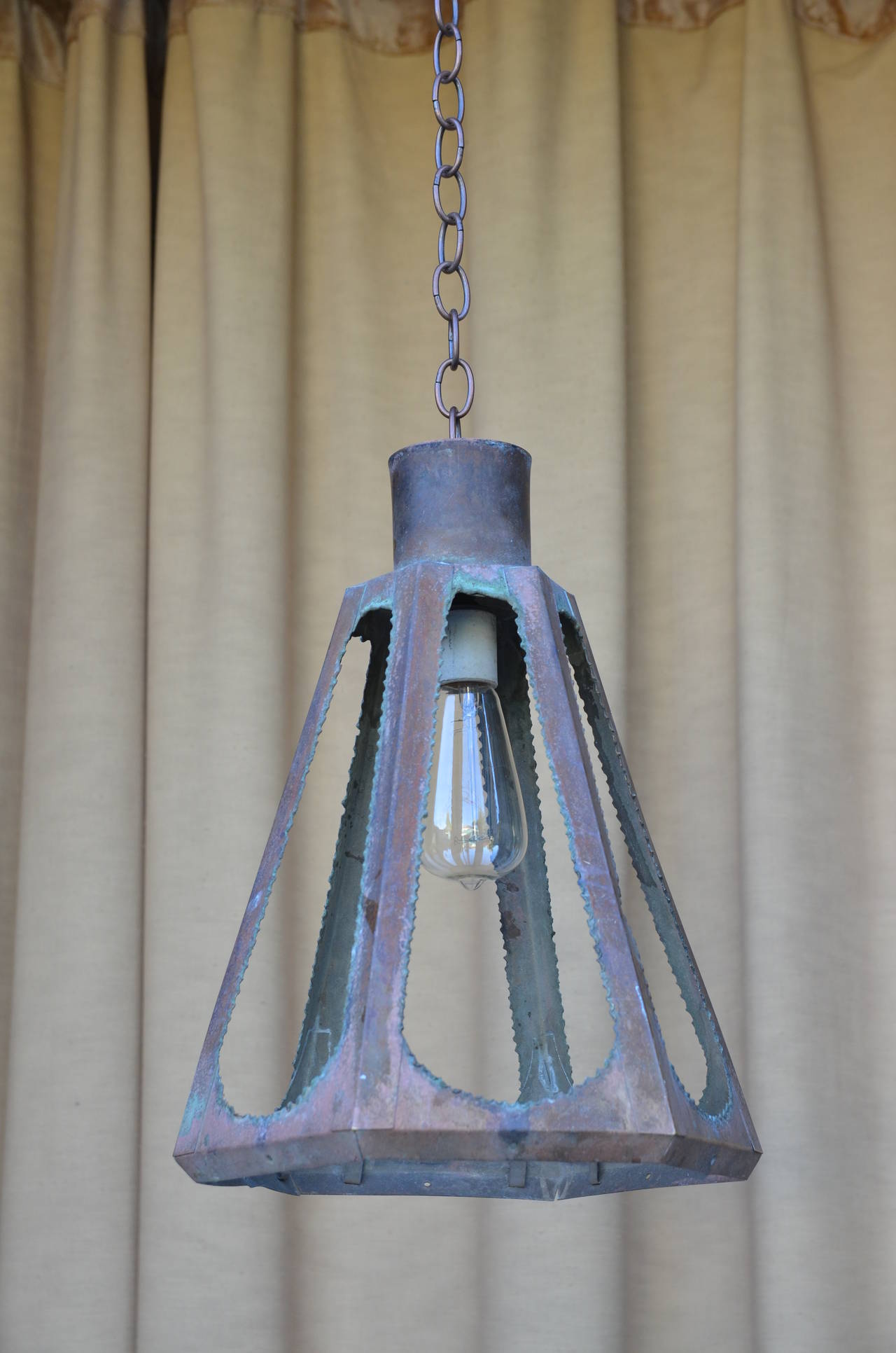 Set of four unusual patinated copper Brutalist lanterns. Suitable for indoor and outdoor use. With adjustable marching chains. Great with Edison bulbs.