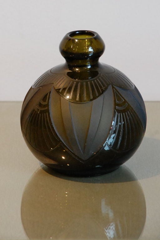 Small Art Deco vase by Legras, in smoked-green glass, acid etched geometric motif. Signed.<br />
<br />
About Legras:<br />
<br />
In 1864 Auguste Legras took over the St. Denis glassworks and founded Legras. He was already an experienced