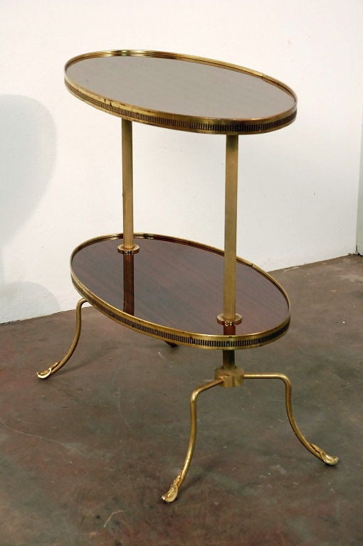 Two tier oval mahogany and brass side table