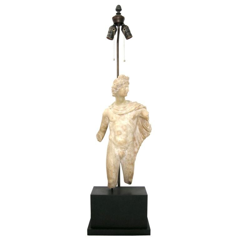 (Now on sale for 3,800.00 base w/shade, reduced from 9,000.00)
19th Century Italian Carved Alabaster Statue of Apollo Belvedere Now Mounted as Lamp on Later Ebonzied Wood Base.  Overall size:  11Wx6.5Dx38H (statue is: 9Wx4Dx19H).  Includes custom