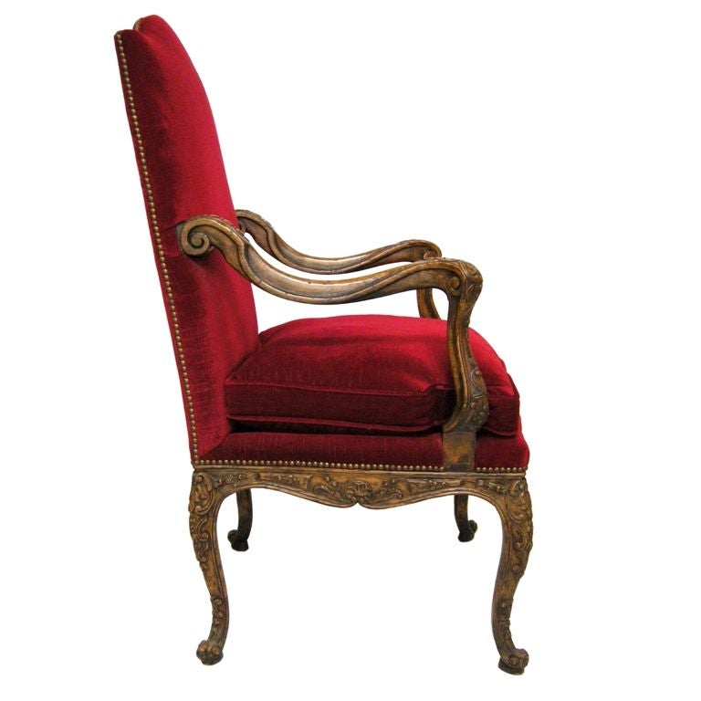 French Regence Style Carved Walnut Arm Chair.  Upholstered in Red Silk Velvet, with Nail-Head Trim.  Overall height is 45.5H, arms height is 28H.  From the former Rothschild Hancock Park Estate
(Showroom Closing/Liquidation, Now on final sale for