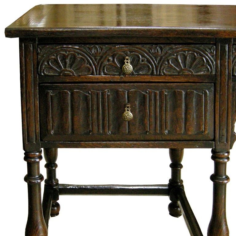 Continental Carved Oak with Dark Walnut Finish 5-Drawer Desk with Brass Pulls.  Carved All Around with Linen Fold & Rosette Motifs.  Note: Chair/Apron Clearance is 26.5H, Overall Height is 33.
