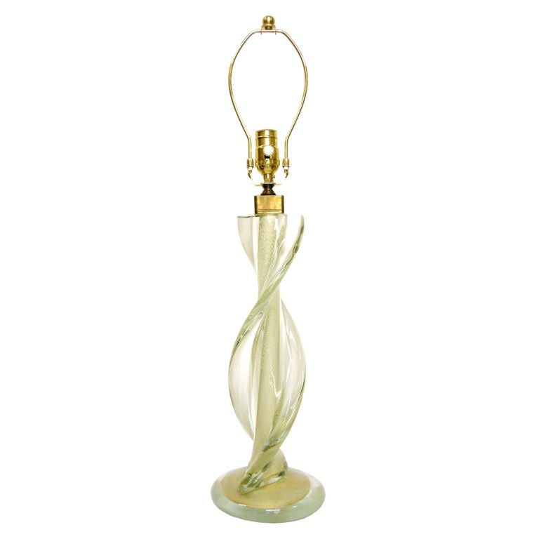 (Now on sale for 900.00 base only, reduced from 2,400.00)
Italian Murano Twisted Light Green Tinted Glass Lamp with White and Gold Fleck Center.  Has original Camer Glass/NY Made In Italy Label on Bottom. Height is with harp 27H.  Note: Shade shown