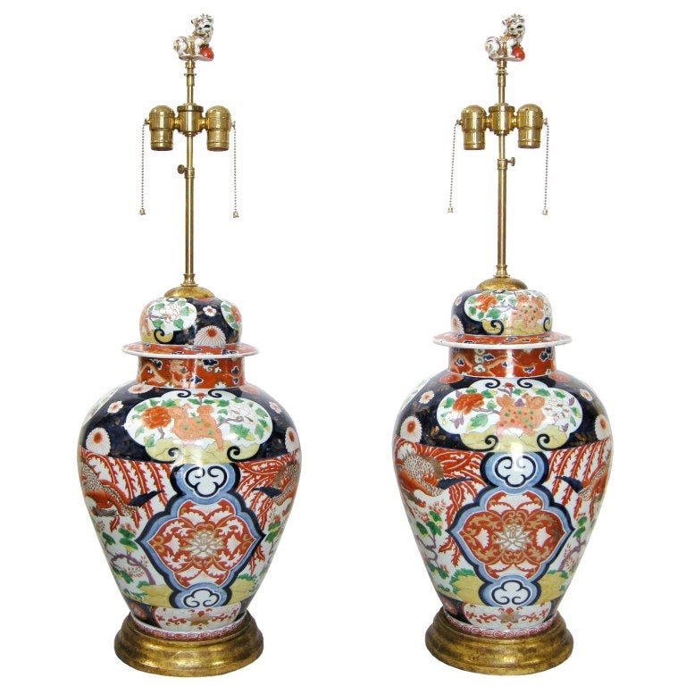 (Now on sale for 2,700.00pair incl.shades - reduced from 5,400.00) Pair Japanese Imari Lidded Urns Now Mounted As Lamps on Giltwood Bases. Original Foo Dog Figures Now As Finials.  Includes Custom Pleated Silk Shades (as shown). 
Note: Size Bases: