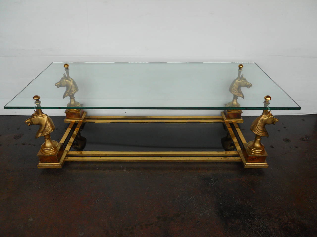 Playful Maison Charles horse heads coffee table.
The top layer glass is clear.
The bottom layer glass is tinted.