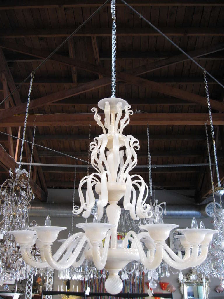 Hand blown in Murano, Venice this beautiful 12 light chandelier will surely brighten your space. 24K gold powder has been infused during the glass making process, which gives a spectacular effect to the glass when it is lit. We also have the