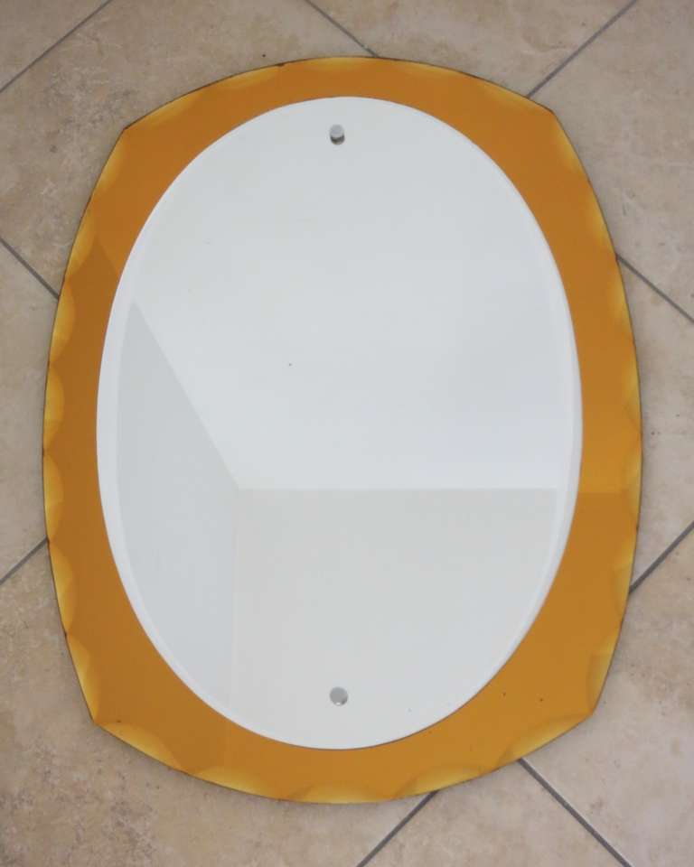 Superb beveled amber mirror in the style of Fontana Arte.