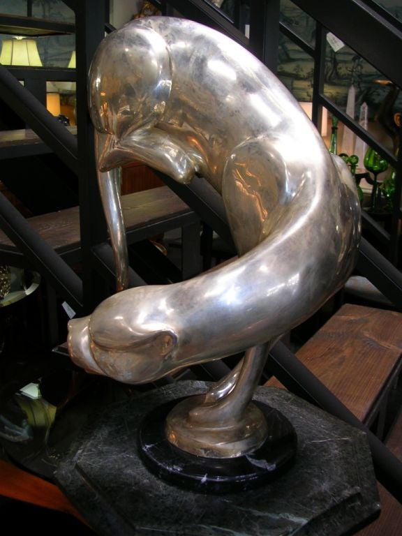 A striking sculpture of a silverplated panther on a black and white marble base. Signed A. Tiot. Diameter of the base is 7 inches.