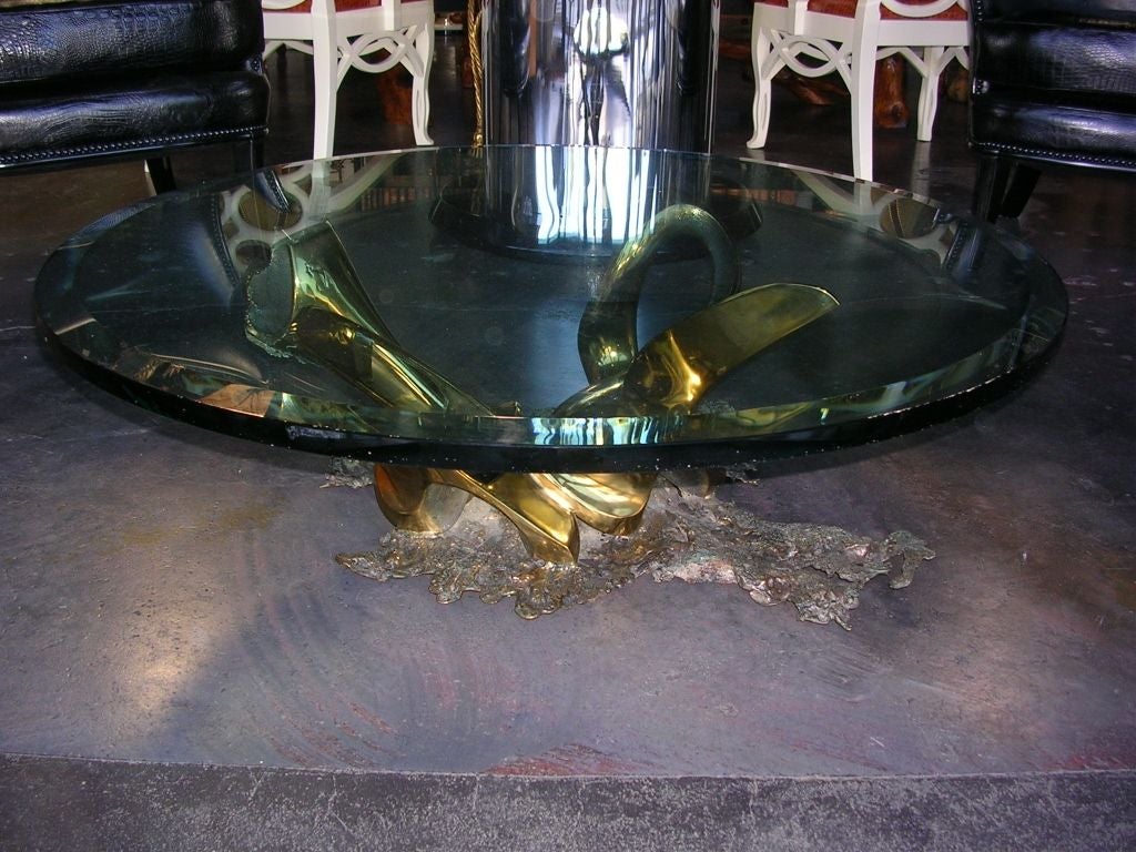 A signed and dated free form bronze coffee table by Tom Bennett. Signed and dated 1988 and 1/1 (one of one). Has a round beveled 3/4