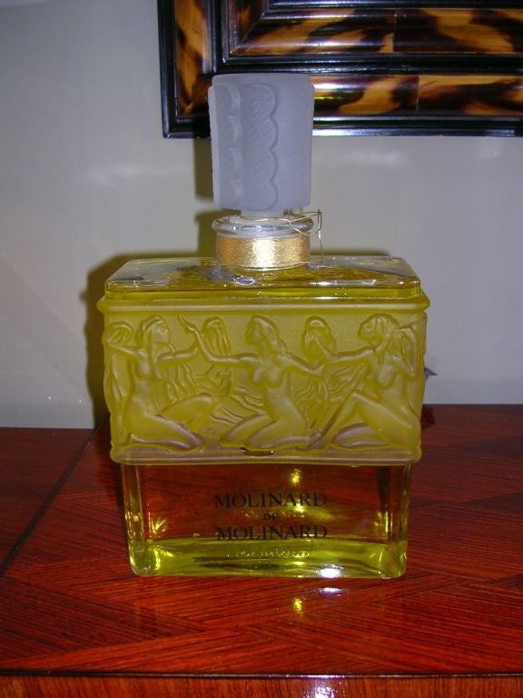 A large vintage perfume bottle in the Art Deco style. Made by Lalique for Molinard. This is the older make with the Molinard  name impressed on the base.