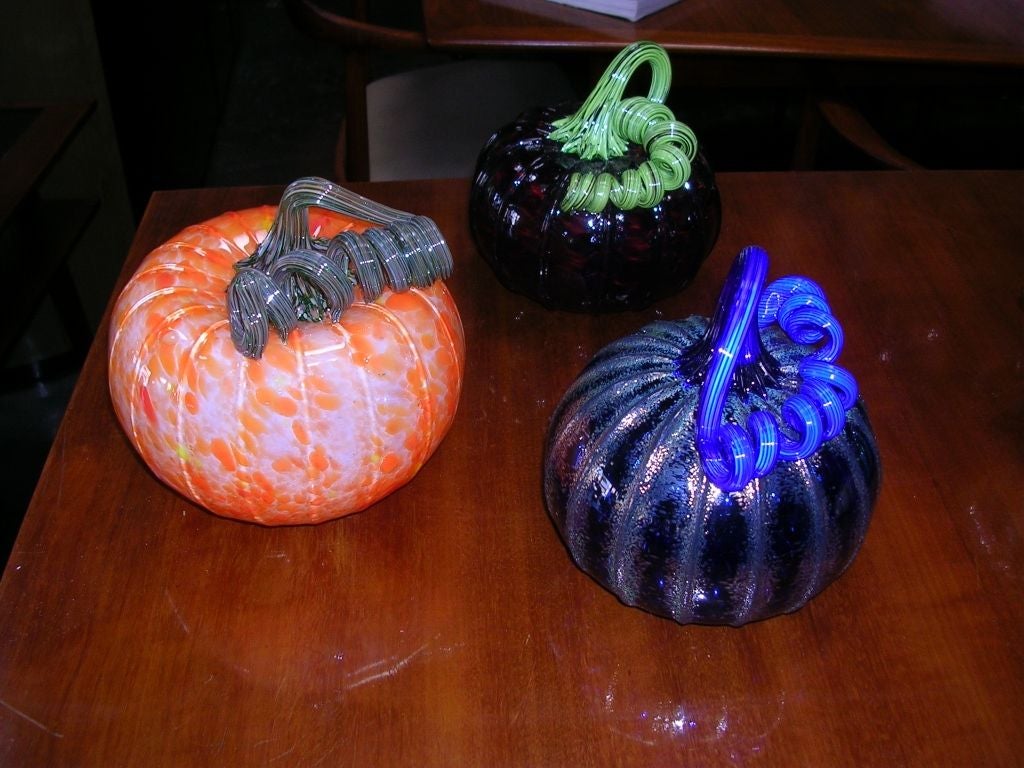 A set of eight hand blown glass pumpkins by John F. Glass. Various sizes. Largest is 6