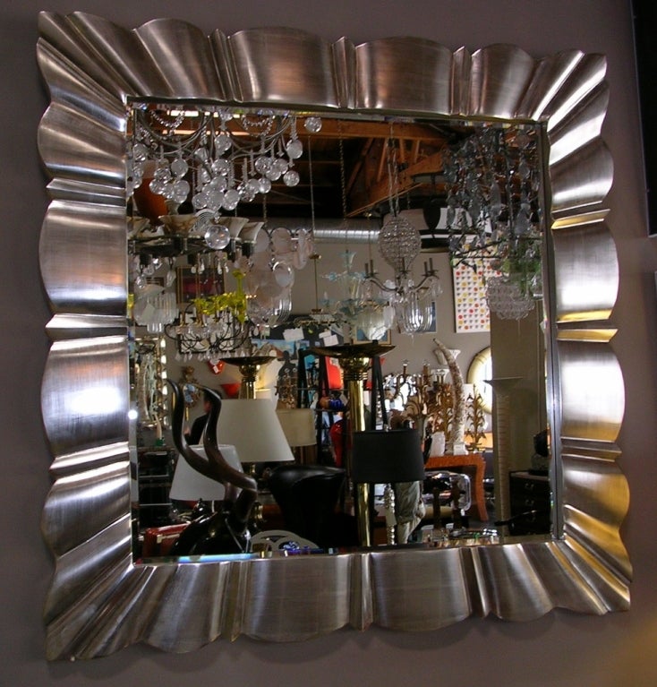 A spectacular real 22k white gold leaf mirror by Bryan Cox. Has a radiating scalloped design. Mirror is new and has a 3/4