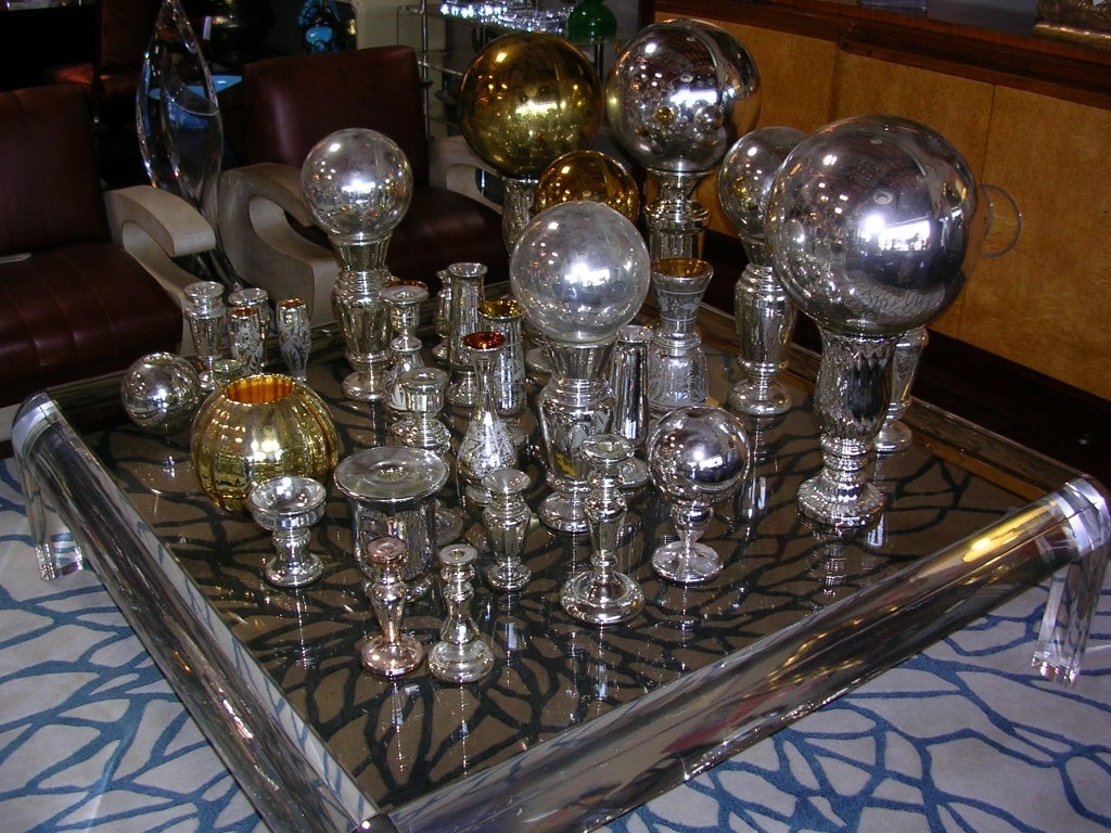 A large collection of old mercury glass objects (vases, bowls, candlesticks and balls). There are total of 41 pieces consisting of 6 candlesticks, 8 balls, and 27 vases/bowls. The largest vase is 14 1/2