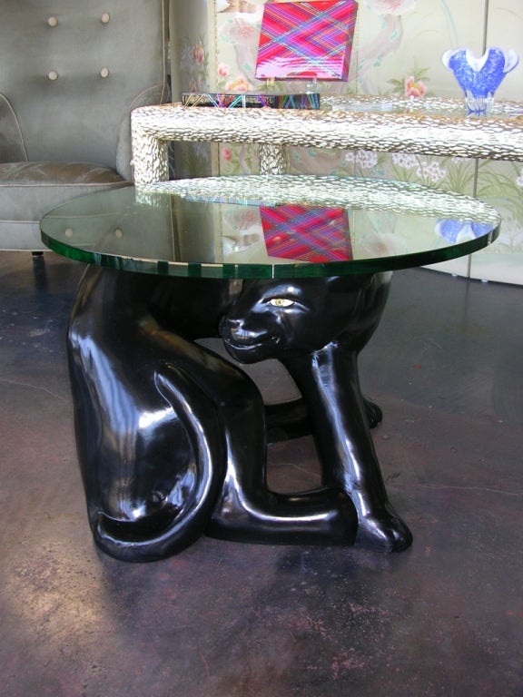 A unique side table with a black panther for a base.