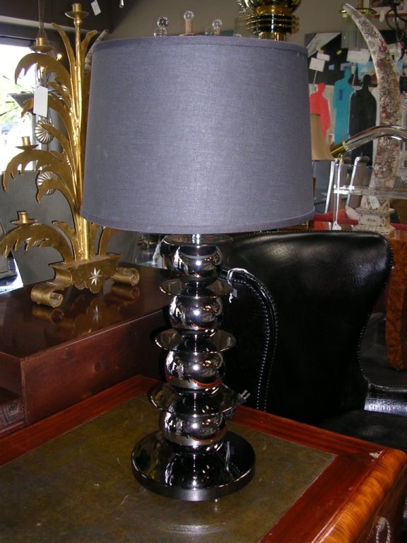 A wonderful pair of smoky chrome table lamps with graduated balls accented with round disks. Height to the top of the finial is 32