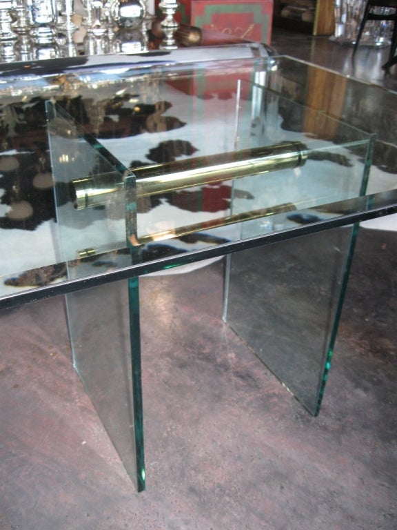 A Modernist side table by Pace International. Legs are held together by two brass horizontal tubes.