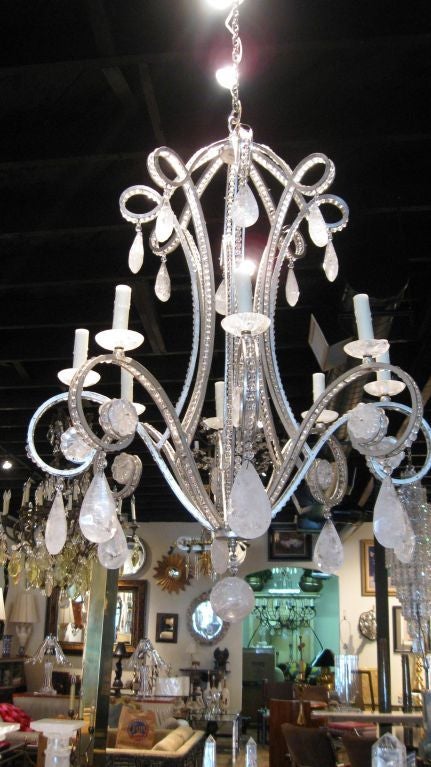 Silver leafed iron and rock crystal chandelier with crystal beads imbedded in the eight metal arms. A second chandelier is available if a pair is needed.