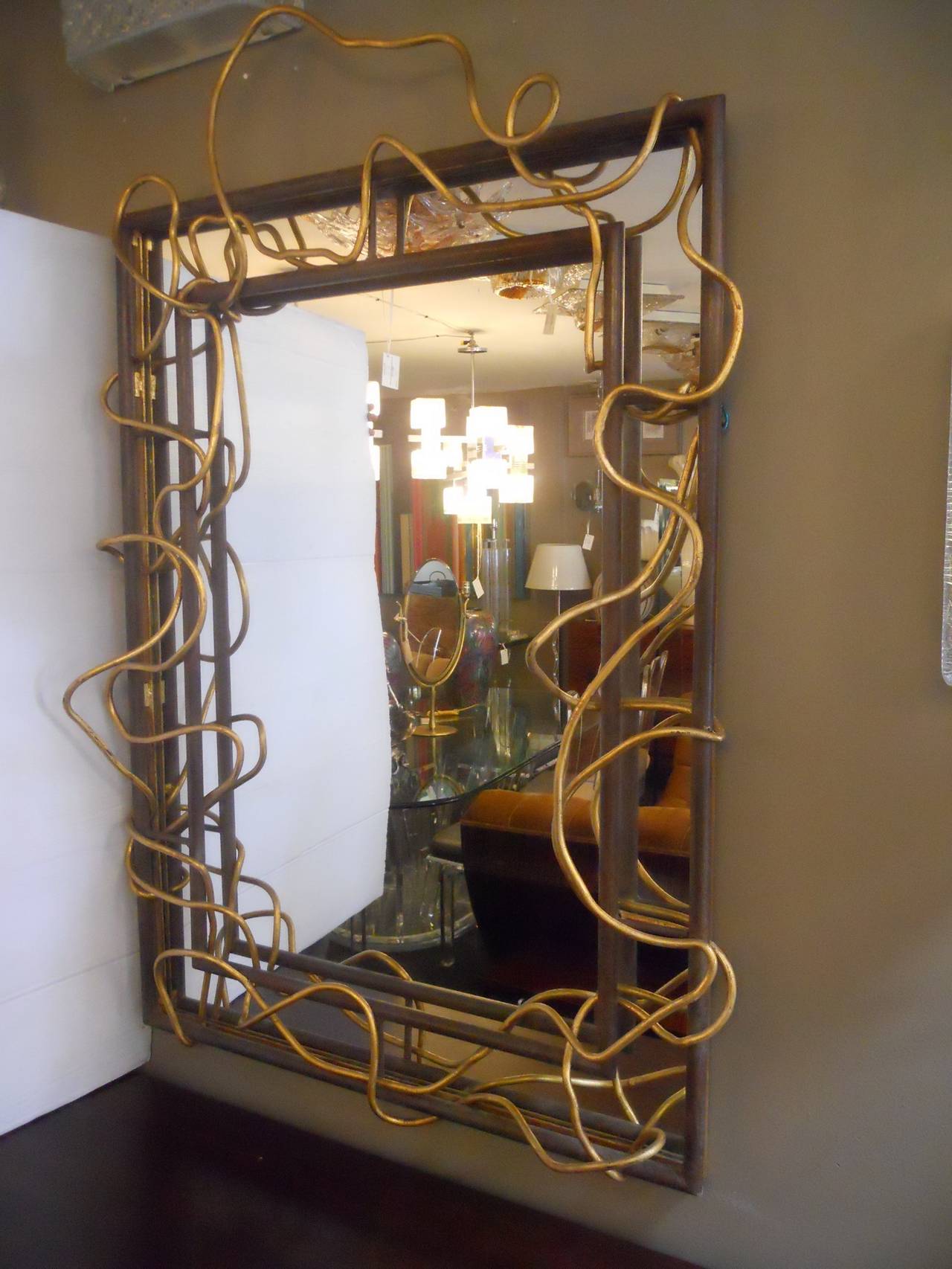 Substantial modernist mirror,
metal rusty patina and gold.