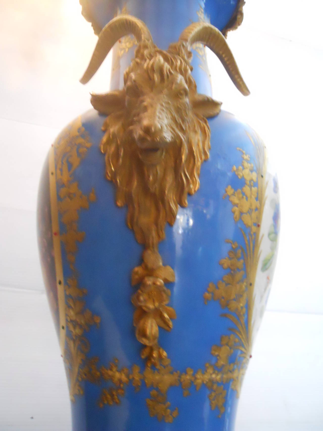Ornate pair of cobalt porcelain and gilt bronze sevres Urns.
Measure: Base W 11