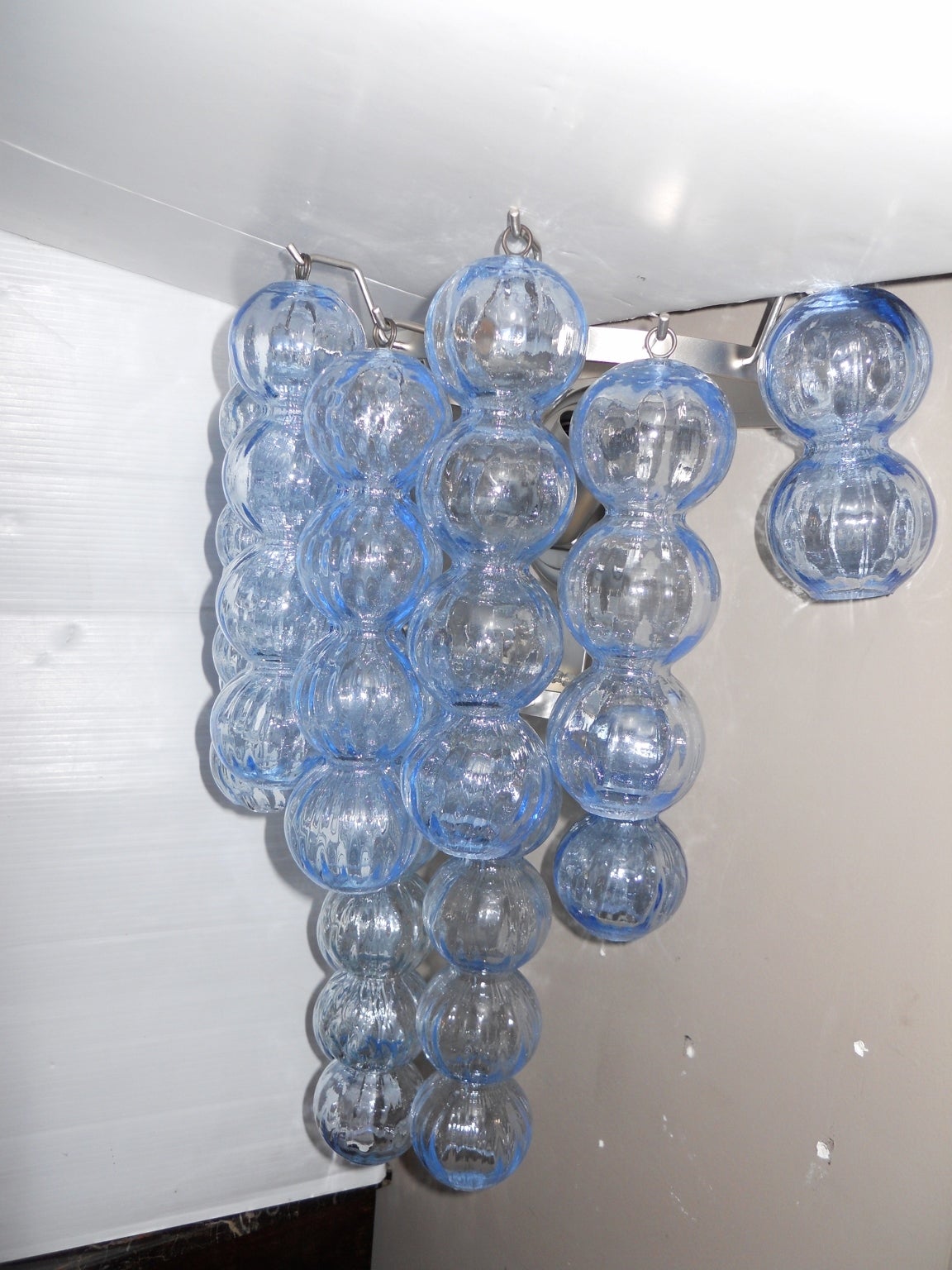A pair of large blue Murano glass ball sconces. Each sconce has a chrome frame and two lights. Price shown is for a pair. There are four pairs available.