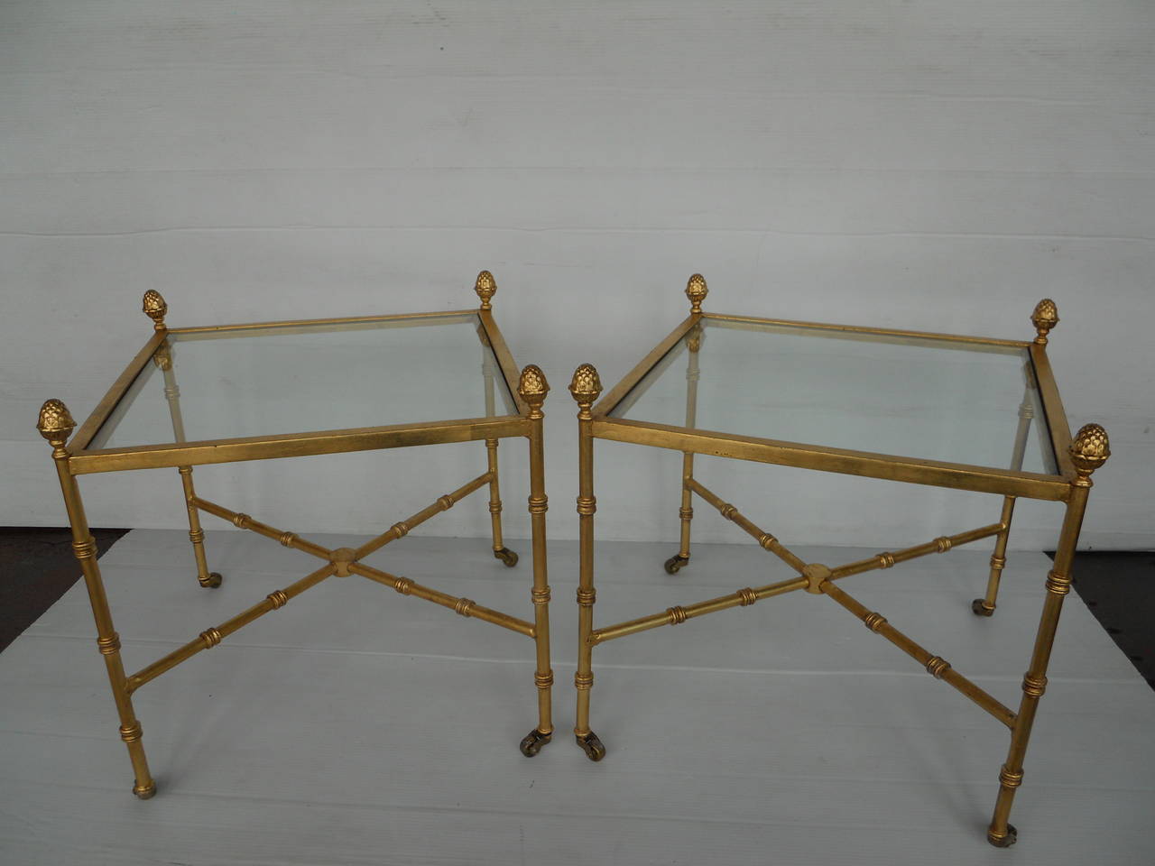 Pair of American vintage side tables.
Metal with gold leaf.
Made in modern interpretation of Empire style.
Actual height of the table where the glass top ends is 18