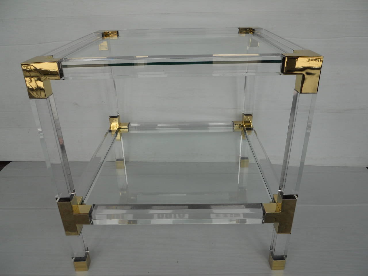 Pair of Charles Hollis Jones metric side tables with brass hardware 
glass top
tasteful and sleek look with chrome and brass combination.