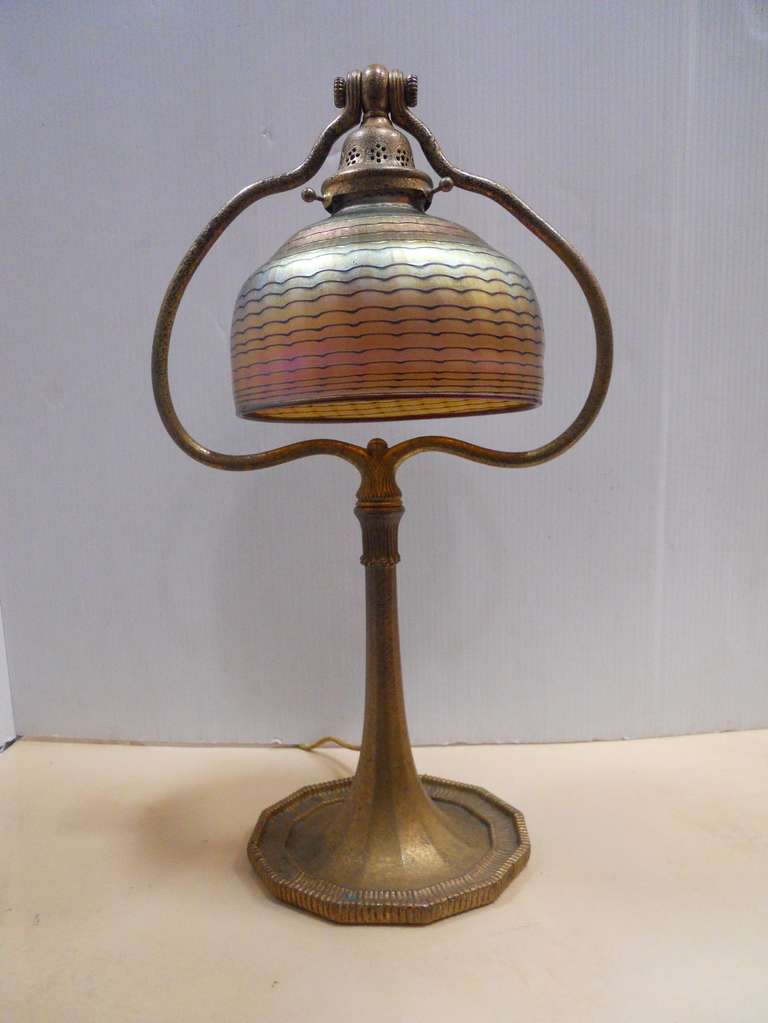 Very special Tiffany Studios table lamp, bronze with a gold dore patina, with an art glass shade, base signed Tiffany Studios New York, #613.