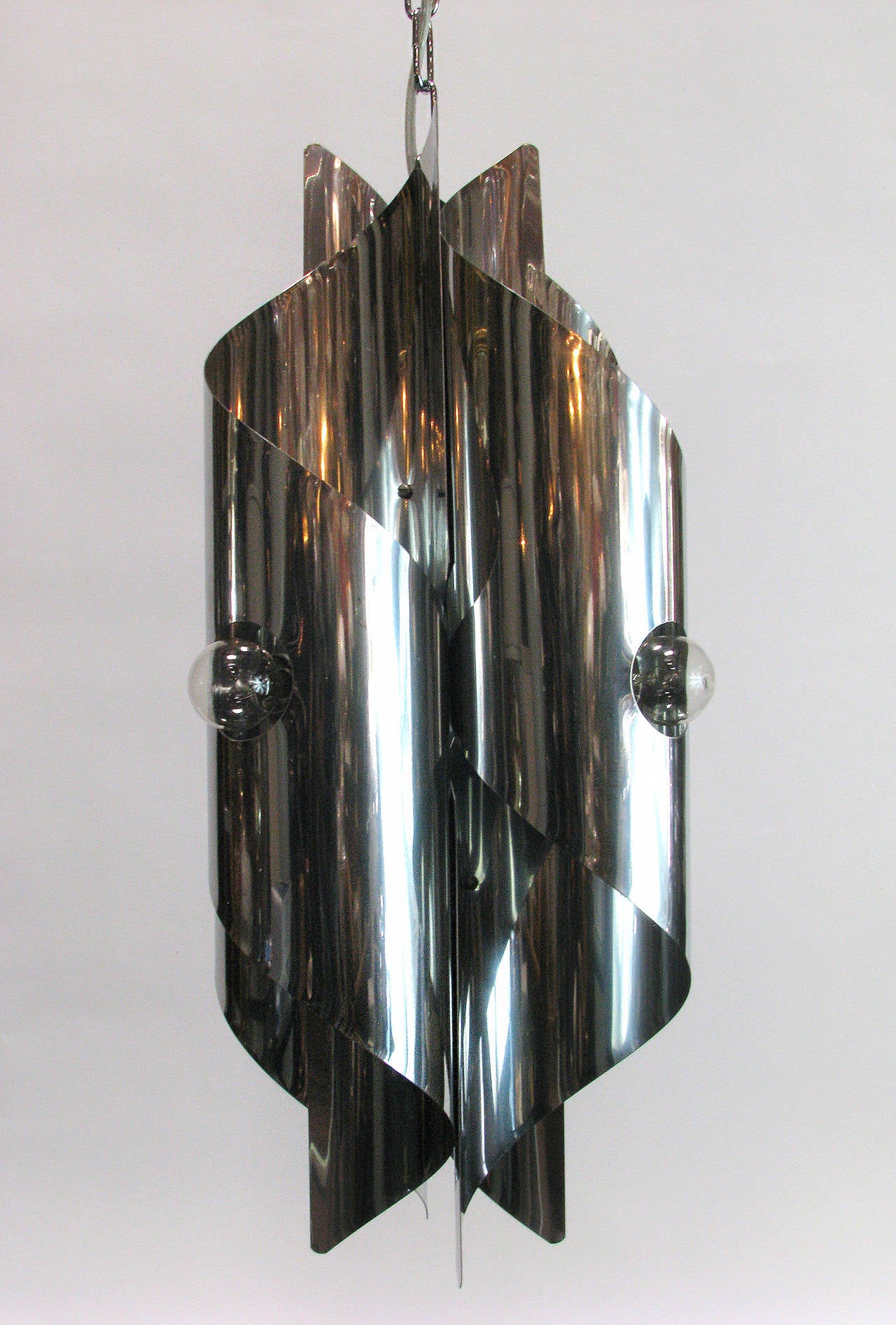 A small chrome spiral chandelier by Gaetano Sciolari. Has four lights. Fixture alone is 21.5