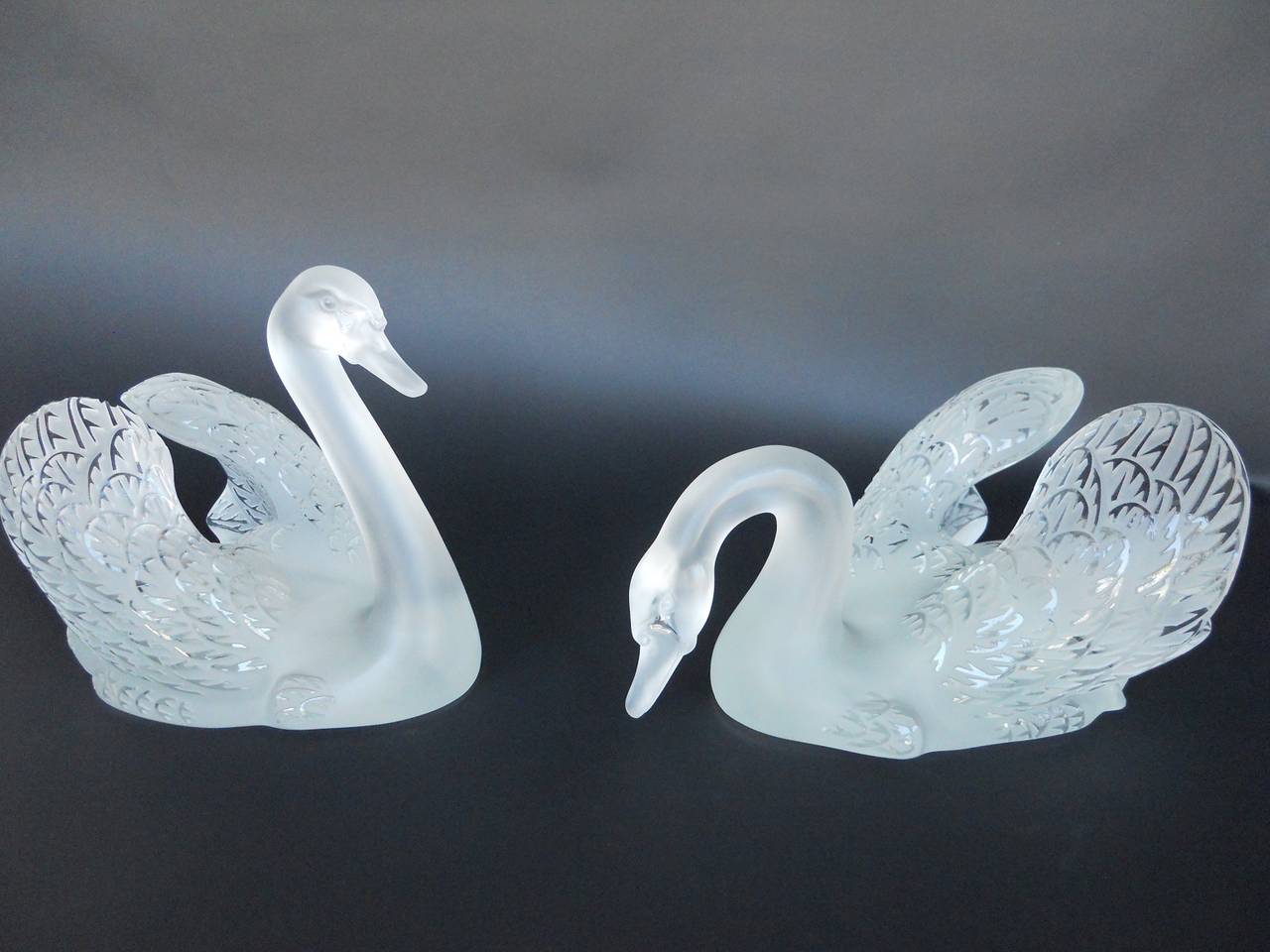 Lalique swan head up and swan head down sculptures.
Handcrafted in France.
Dimensions (Head Down Swan): H 7.09