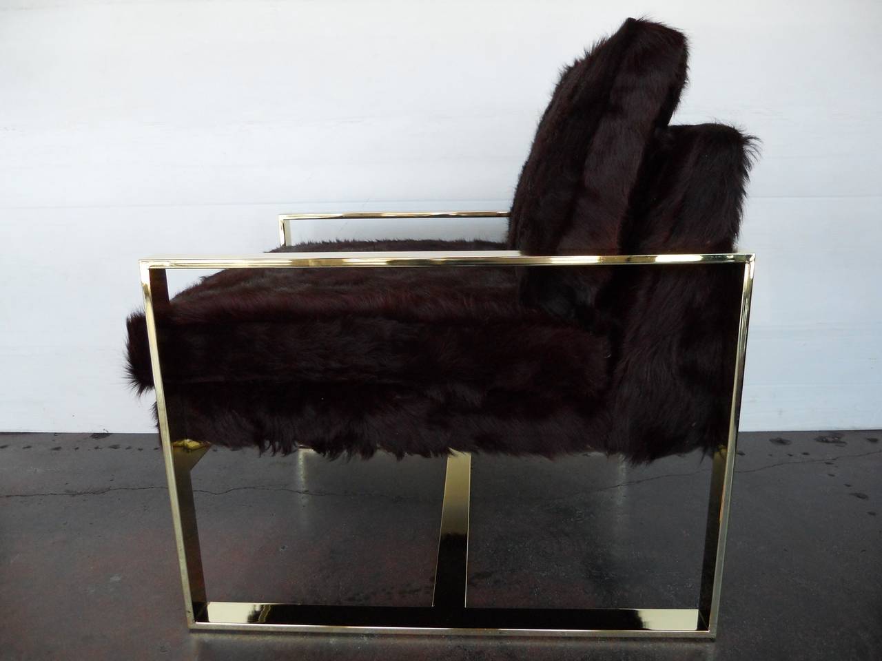 Pair of Milo Baughman chairs
brass-plated metal with newly re-upholstered cowhide.
Measures: 21.5