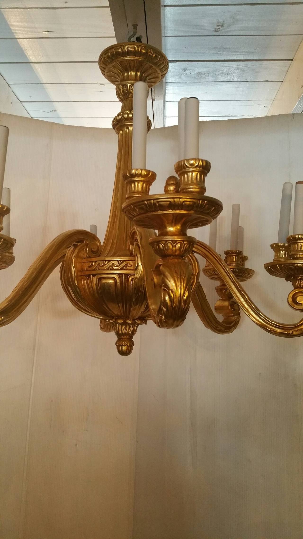 Hand-carved 19th century chandelier. 
Newly gold-leafed and rewired. 
Six arms.
18 lights.
