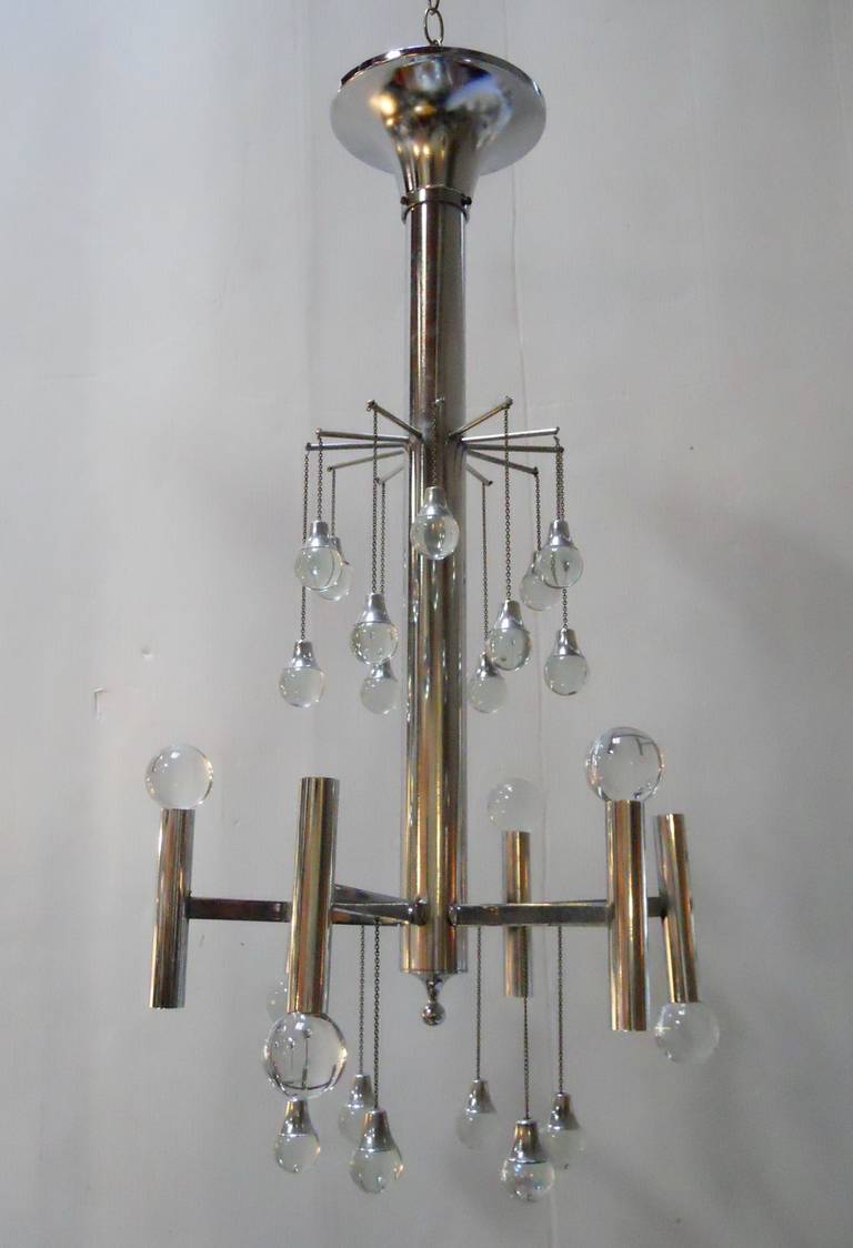 Fantastic Sciolari Chandelier 
The measurements below include the rod and the original canopy
The warm tone reflections on the body of the chandelier are just from the surroundings. The fixture is chrome.
Six lights total (three facing up and