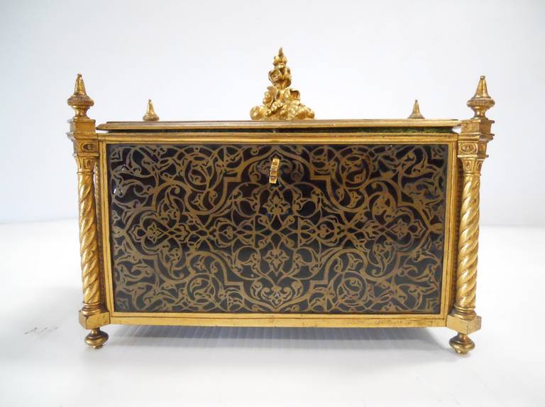 An amazing late 19th century French Gothic Revival casket in bronze and enamel. The hinged lid is decorated with a foliate finial of fruits and flowers. Beautiful scroll work design throughout the box. Each side is ornamented with a turned design
