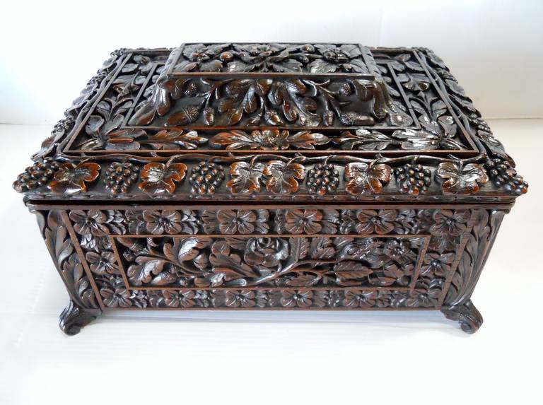 An amazing hand carved Oak Wooden Box, could also be used as a tea caddy. Amazing details hand carved all through out the box that include flowers, grapes, leaves, and other details. This box is constructed from solid oak and is an exceptional piece