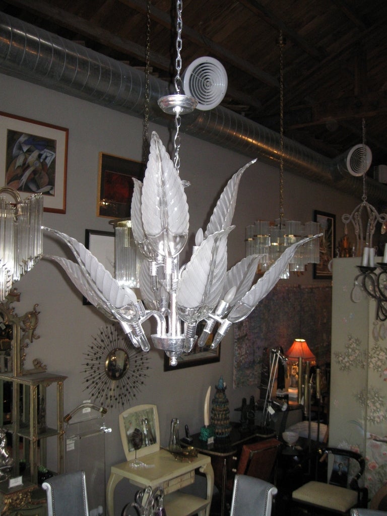 An elegant Murano leaf chandelier. Has nine bubl sockets. Dedorated with well detailed long glass leaves. Height to top of the upper canopy is 32 inches and to the top of 1st canopy (before chain) is 22 inches.