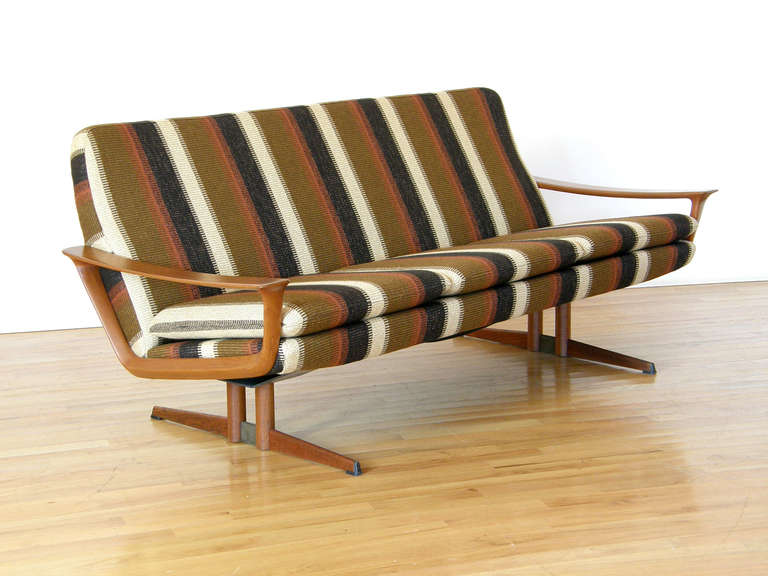 Cool 1960's sofa with sculptural teak arms and teak over steel frame. Johannes Andersen for Trensum, Demark.