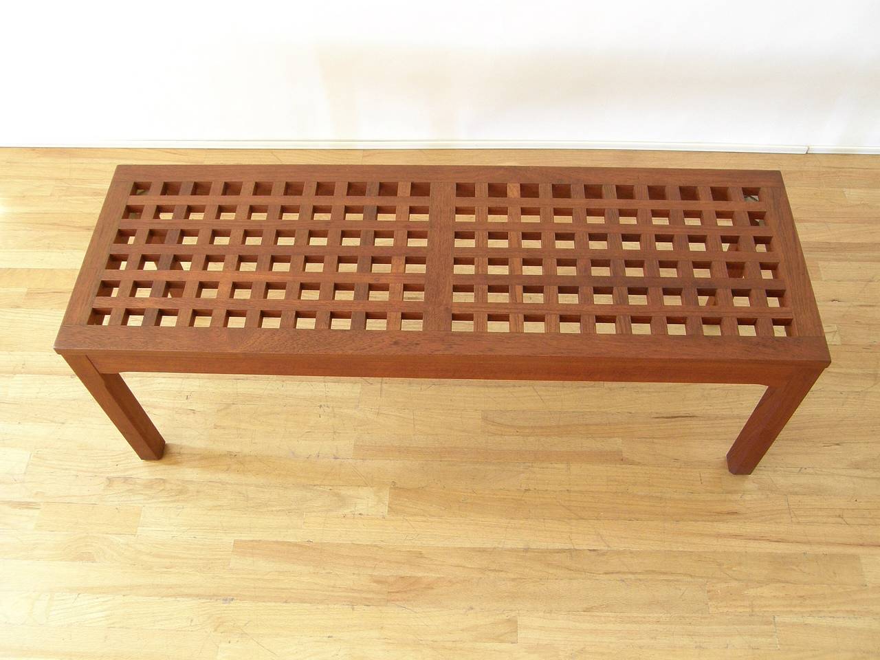 Rectangular teak cocktail or coffee table with a grid form top. This table would also make an excellent low display table or plant stand. The design is reminiscent of the grid form trays designed by Jen Quistgaard for Dansk.

attributed to John