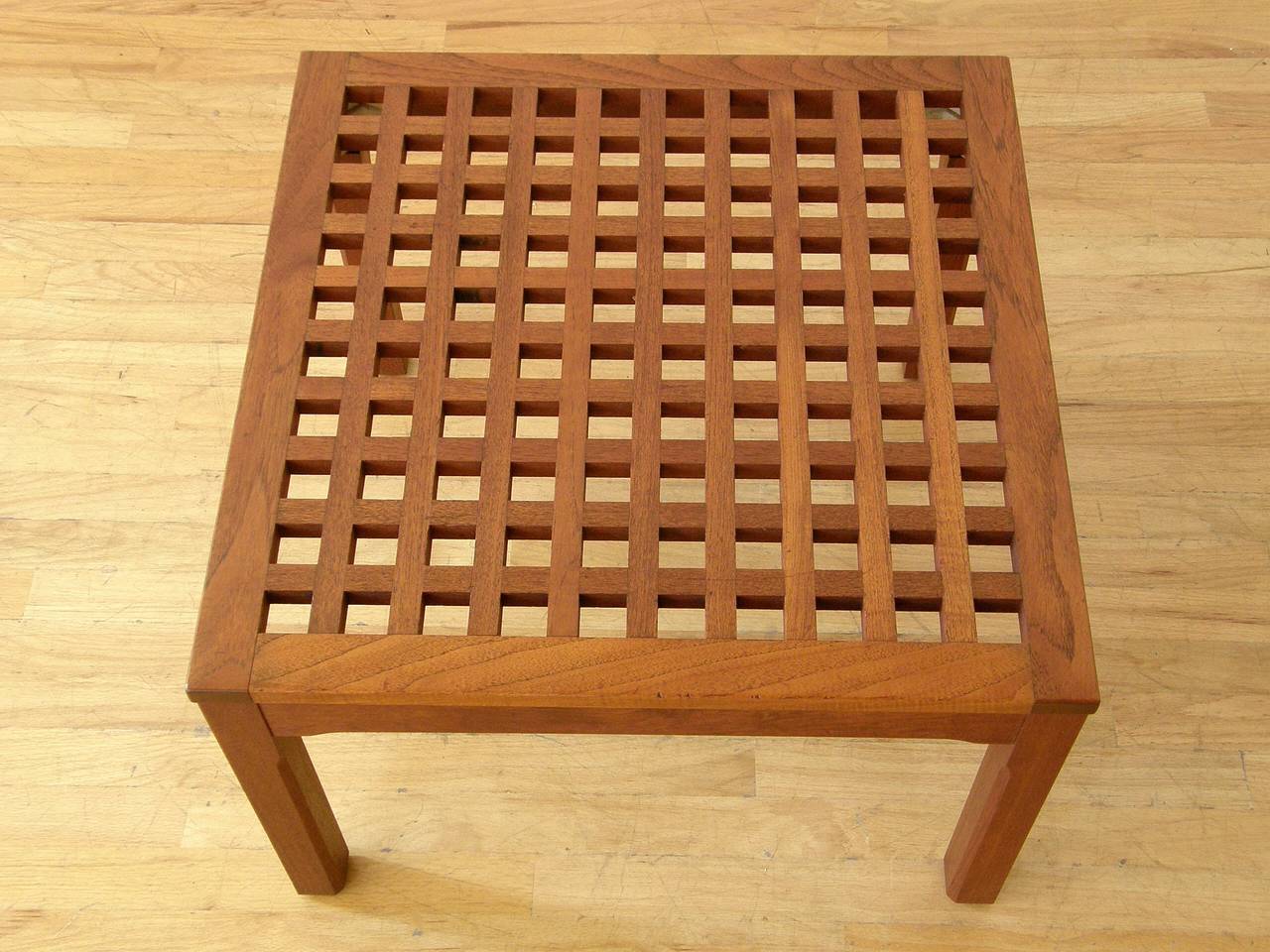 Square teak table with a grid form top. This versatile piece can be used as a coffee table, side table, or corner table. The design is reminiscent of the grid form trays designed by Jen Quistgaard for Dansk.

Please contact us if you have any