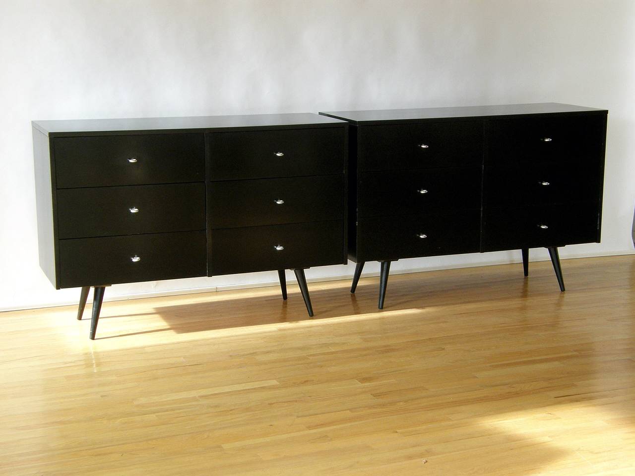 Pair of six drawer Paul McCobb dressers with a black painted finish and aluminum ring pulls.

Please use Contact Dealer button if you have any questions.