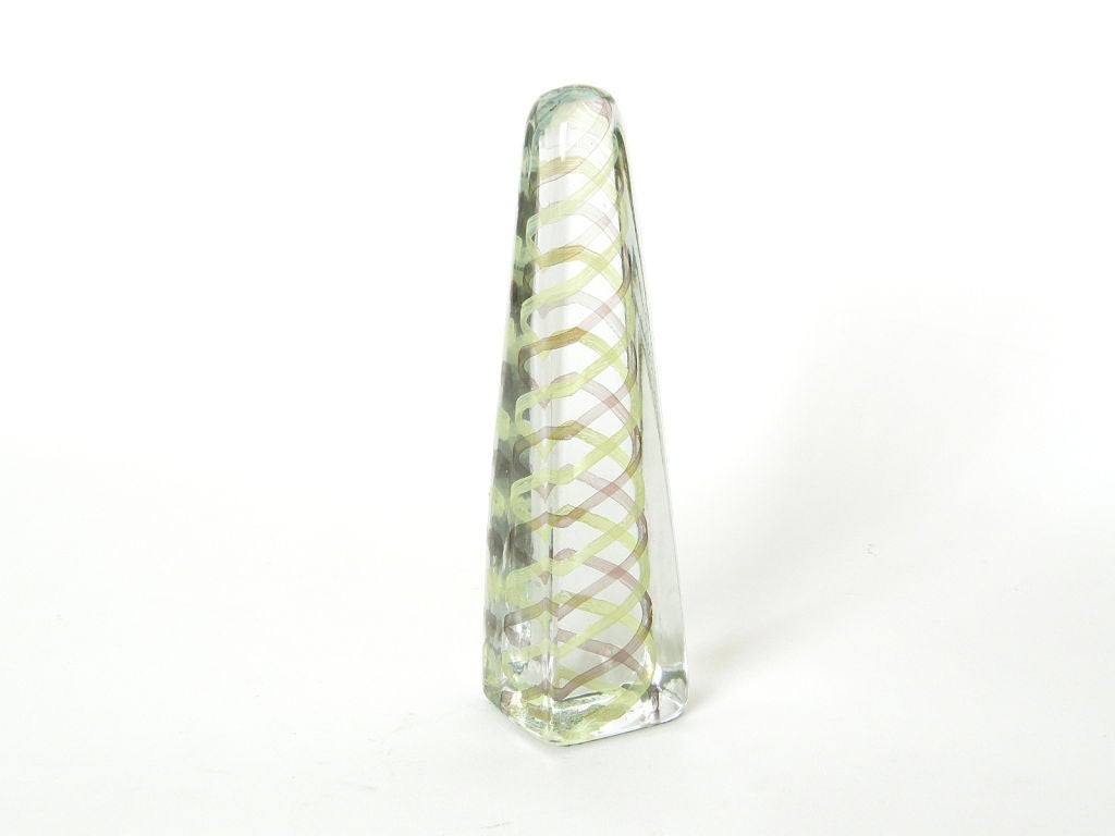 This Venini obelisk sculpture has soft, rounded edges. There are striped bands of chartreuse and maroon that spiral around each other as they run through the center of it.

Please contact us if you have any questions.