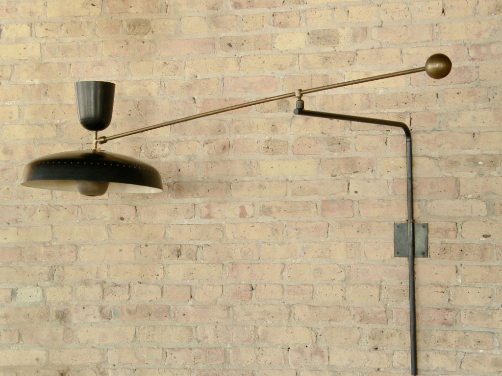 Wall mount lamp by Pierre Guariche. Articulated arm with brass ball counterweight, up and down light source, a great example of 50's french design.