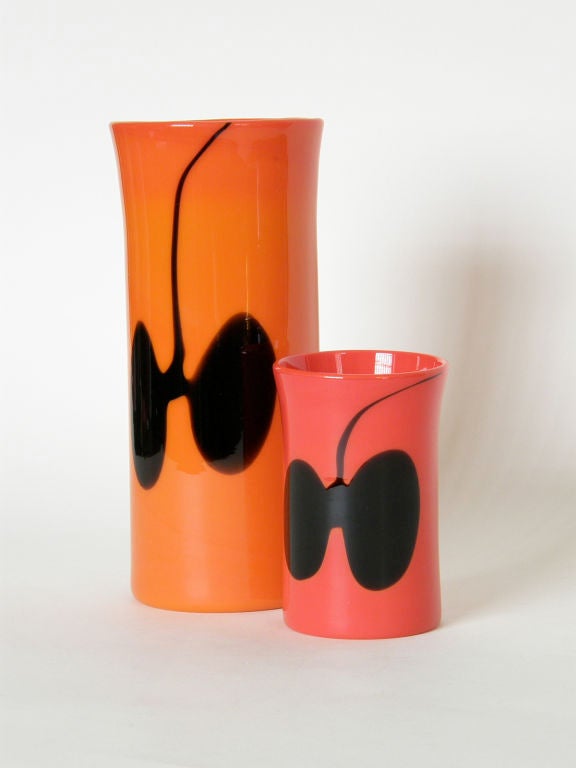 This pair of glass vases were designed by Heikki Orvola for Nuutajarvi Notsjo, Finland. The orange and red base colors contrast nicely with the abstract black designs, and the two different heights complement each other.

larger: 10 1/8